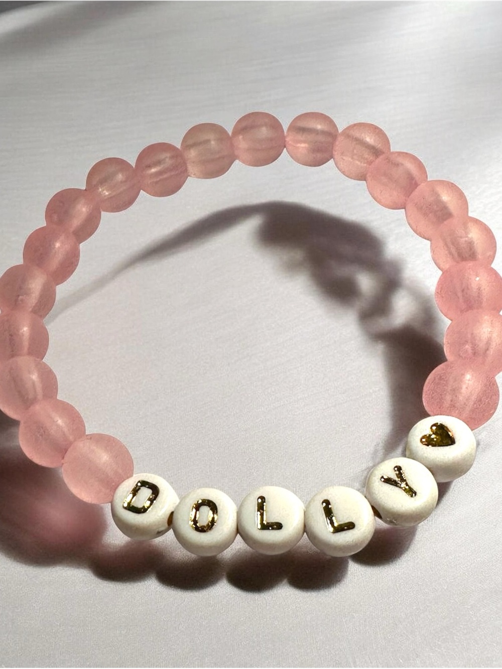 Pink Frosted Dolly Parton handmade beaded bracelet with Gold Lettering